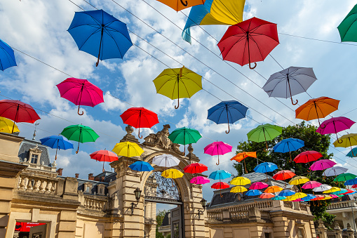 Lviv, Ukraine - 08 June 2018: Colorful umbrellas in the streets. Art object in old city of Lviv. Pedestrian street with bright decoration. Variety of multicolored umbrellas. Lviv cityscape