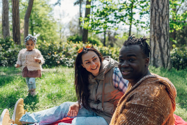 istock Multiracial family having fun in the park 1395562731