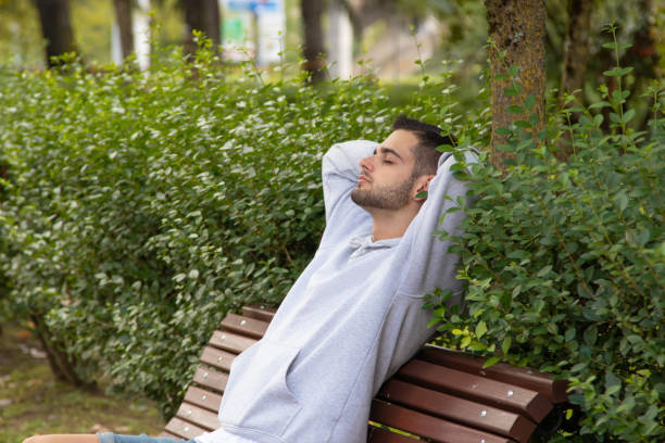 istock young man sitting on the bench relaxed 1395564015