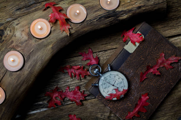 istock Old books and clock by candlelight. 1395565212