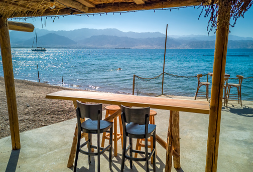 Sandy beach, resting table and chairs with safety cord near paradise bay of the Red Seal, Middle East