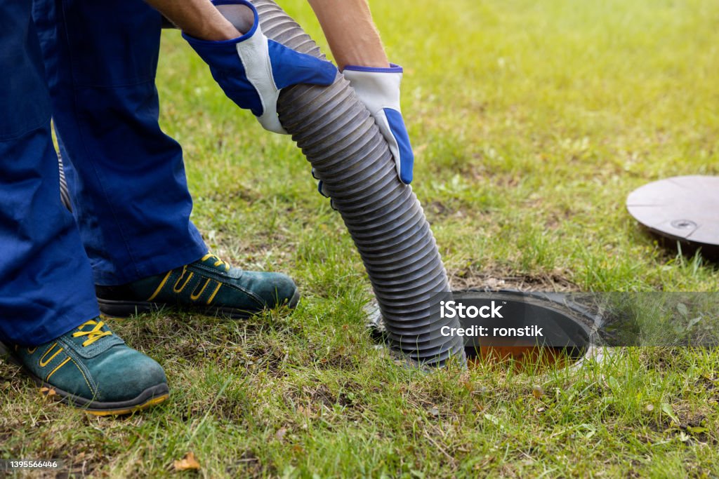 pumping out household septic tank. drain and sewage cleaning service Septic Tank Stock Photo