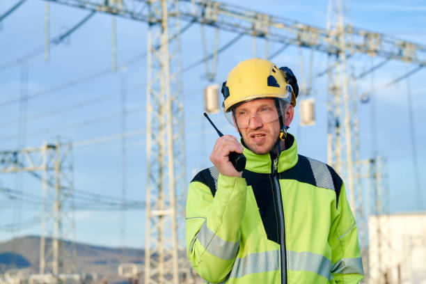 istock Engineer at a high voltage power station using walkie-talkie 1395568131