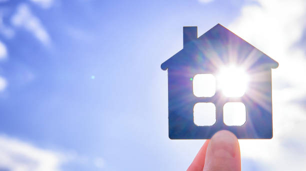 istock Flat wooden house with sun rays 1395568230