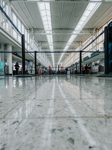 April 6, 2022, Chicago O'Hare International Airport, Floor surface level view of an international airport terminal. Areas roped off for incoming travelers to check in for their flights. Vaulted glass ceiling, modern airport architecture.
