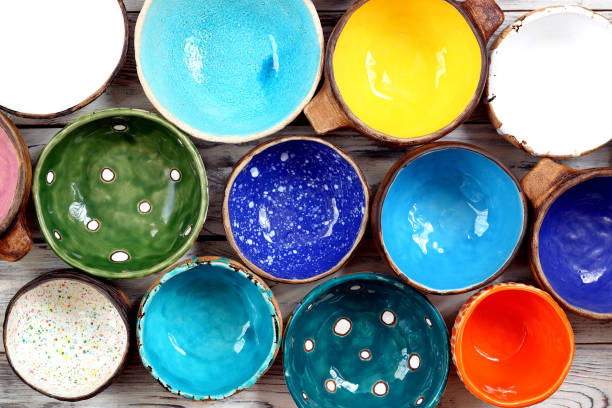 istock View from above on many different bright multicolored ceramic bowls and cups handcrafted on white wooden background. Top view. Background texture. 1395570146
