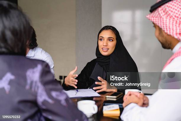 Young Saudi Professional Describing Ideas For New Business Stock Photo - Download Image Now