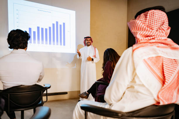 istock Financial officer presenting data to Saudi executive team 1395570306
