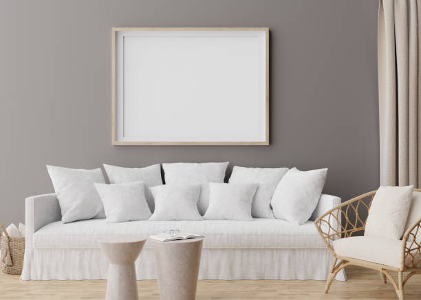 istock Empty horizontal picture frame on grey wall in modern living room. Mock up interior in scandinavian, boho style. Free, copy space for your picture, poster. Rattan armchair, sofa. 3D rendering. 1395571704