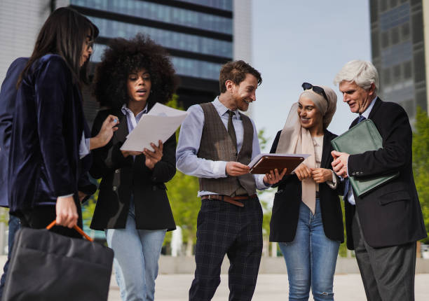 istock Multiracial business people analyze diagrams outdoor 1395574788