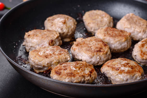 istock Delicious fresh fried minced meat patties on a dark concrete background 1395577367