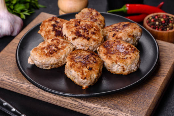 istock Delicious fresh fried minced meat patties on a dark concrete background 1395577436