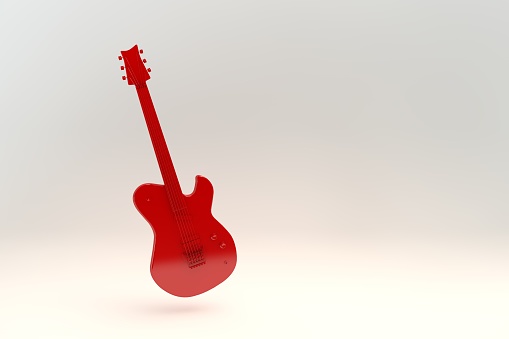 Red electric guitar on a wooden background. Empty space, close-up.