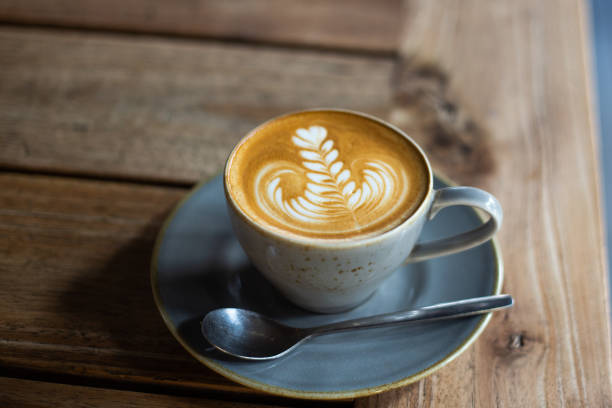 istock Hot coffee with latte art on wooden table at cafe 1395577749