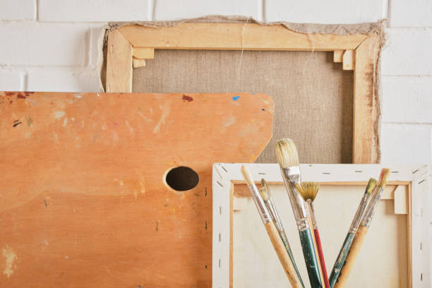 istock brushes, canvases and palette against the wall 1395580165