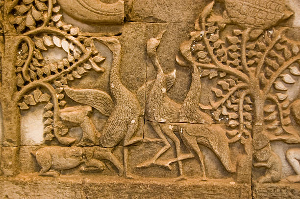 Ancient bas relief carving of three geese dancing.  Wall of the Khmer Bayon Temple, Angkor Thom, Siem Reap, Cambodia