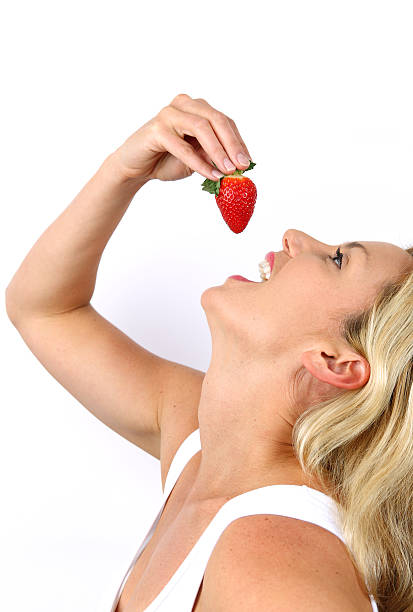 istock Woman Eating a Strawberry 139558413