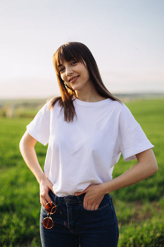 A portrait of a beautiful woman in a white t-shirt supporting Ukraine