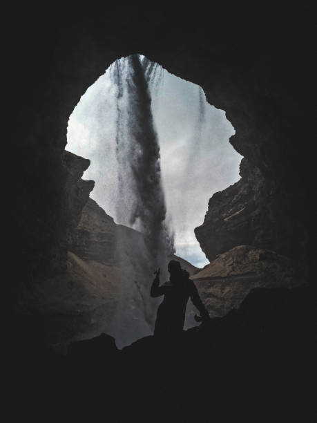 istock One Person Stands Behind Kvernufoss Waterfall Area 1395584931