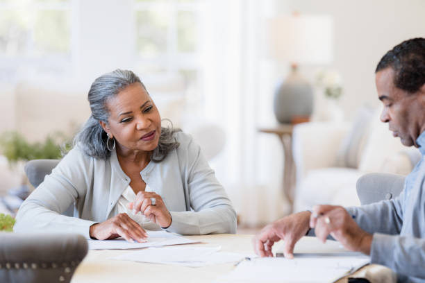 istock Grandparents sit and plan their trip to visit their kids 1395585825