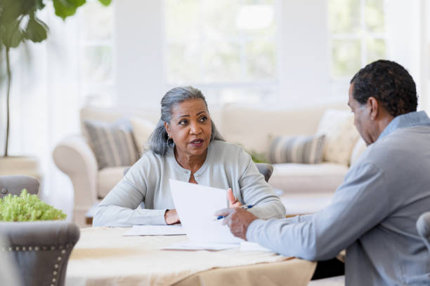 istock Husband and wife discuss insurance plans 1395585834