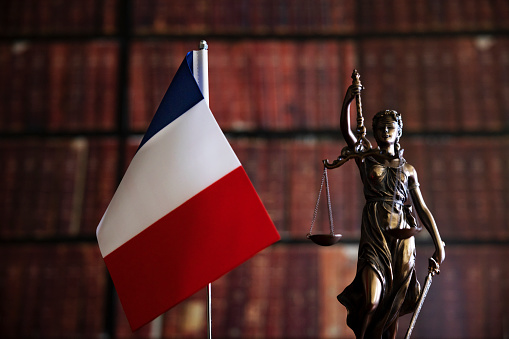Lessons for the future for Law or human rights after the epidemic. Statue of justice in front of law books and French flag