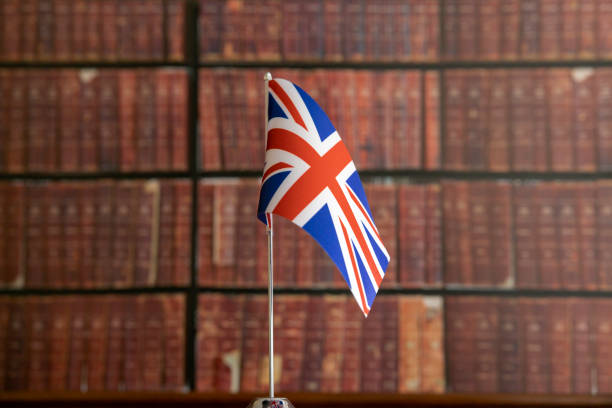 english flag hanging on the metallic pole in front of the library - british flag freedom photography english flag imagens e fotografias de stock