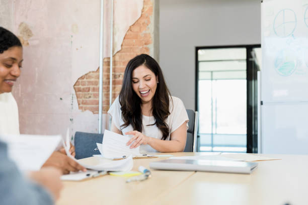 istock Diverse staff discusses paperwork during meeting 1395586909