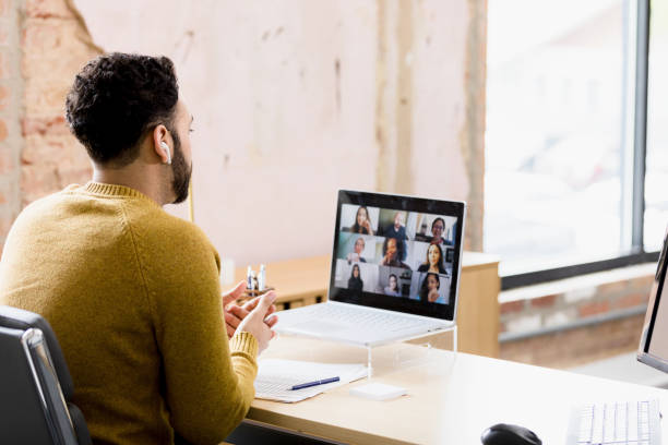 istock Unrecognizable man participates in staff meeting from his home office 1395587179