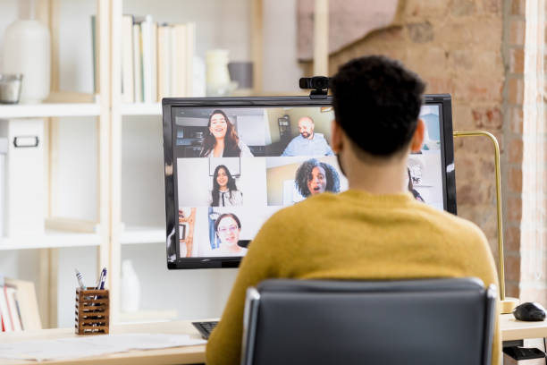 istock Over the shoulder view man attending meeting from home office 1395587187