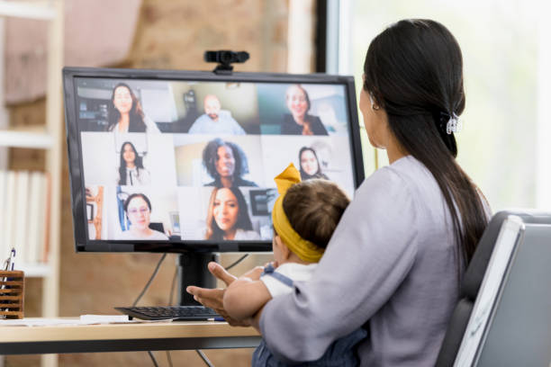 istock Mom holding baby telecommutes for work 1395587188