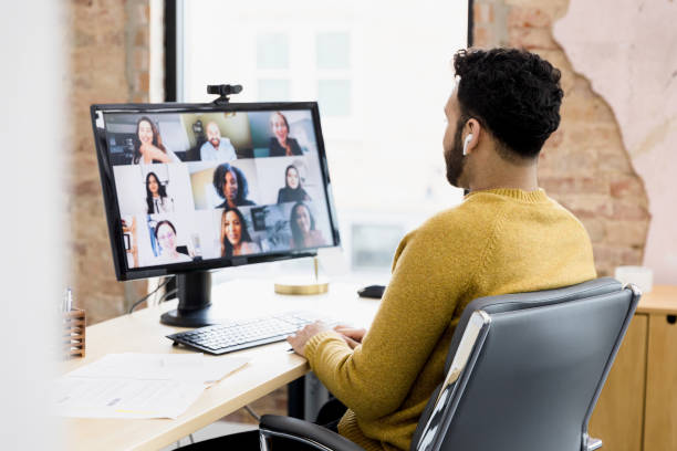 istock Man uses desktop and wireless earbuds to attend meeting 1395587206