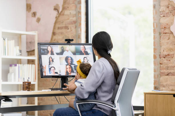 istock Single mother sits at her desk to attend a virtual meeting 1395588070