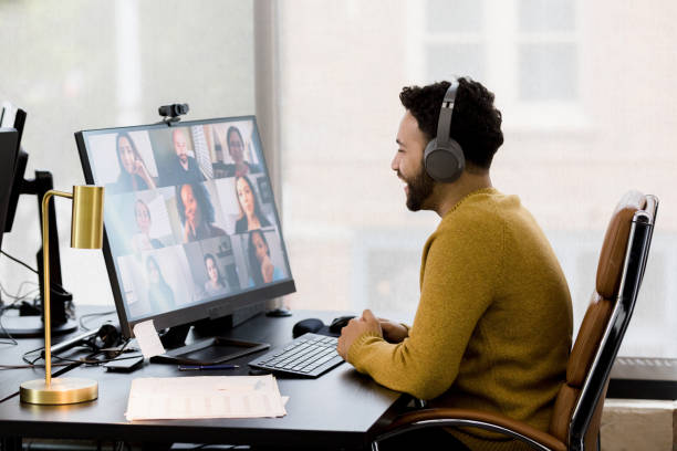 Remote employee uses his headphones to attend a video conference