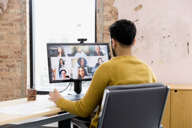 istock Young adult meets with his team virtually 1395588095