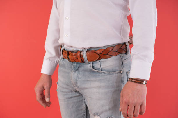 istock Close up man standing in blue jeans and brown leather belt 1395592408