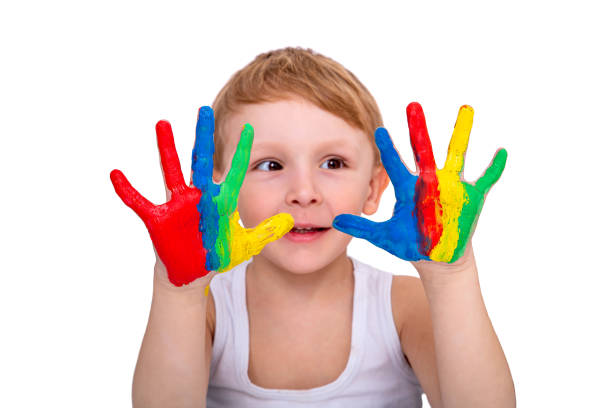 istock The boy shows his hands painted with bright colors, on a white background 1395592494
