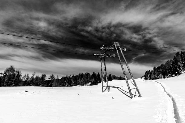old cableway pylons with snow at Cima Larici Asiago Vicenza Veneto Italy