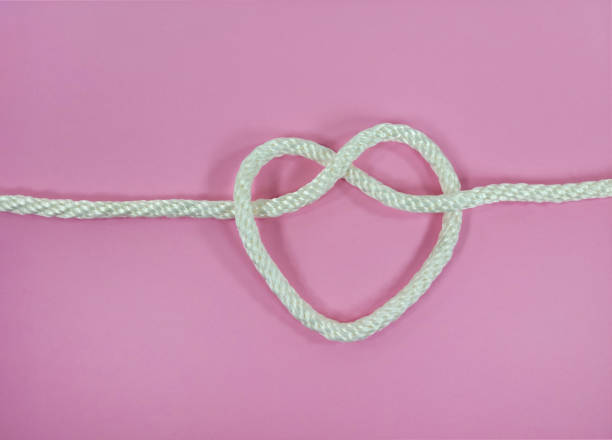 istock White Rope Heart On Pink 1395595946