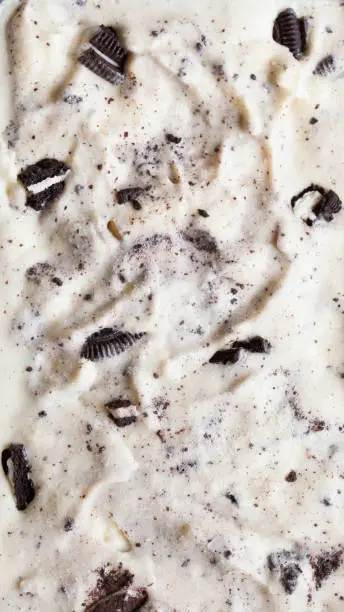 Close-up of homemade cookies and cream ice cream showing the texture of a gallon of cookie ice cream.