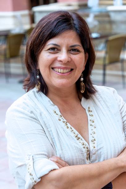 istock smiling mature hispanic woman looking at the camera 1395596783