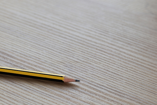 A top view of a broken pencil on a white background