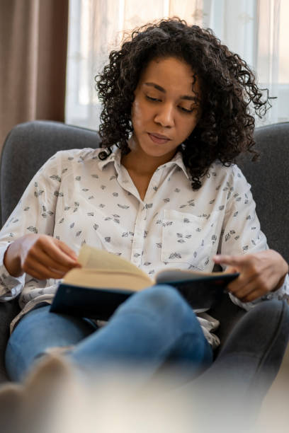 istock Young woman relaxing reading a fantasy book 1395597302