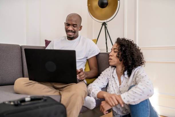 istock Afro couple looking at a laptop at home 1395597304