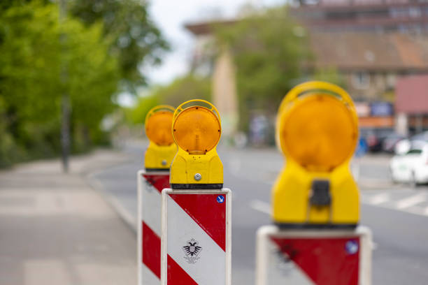 Cologne, Germany: Apr 21st 2022: Traffic cones with blinking lights are used to warn drivers from road work in Germany.