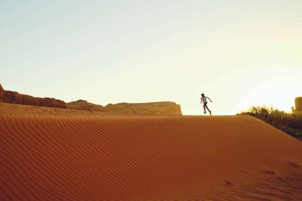 A Native American Navajo young girl playing in the desert at Monument Valley USA.