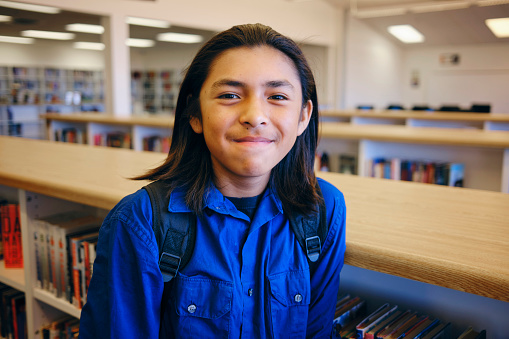 A portrait of a Native American Navajo high school student in a school library.
