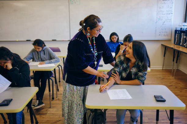 istock High School Teacher and Students in a School Classroom 1395602120