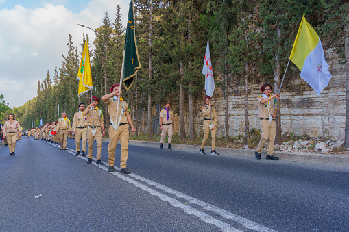Haifa, Israel - May 01, 2022: Scouts and others take part in the Our Lady of Mount Carmel parade, near Stella Maris, in Haifa, Israel. This annual event commemorates the hiding of Mary statue in WWI