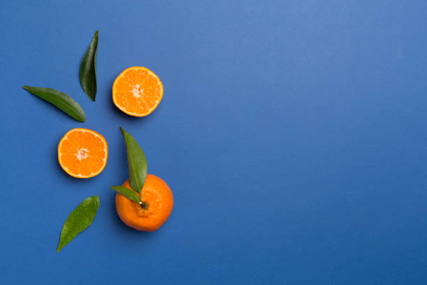 istock Flat lay with fresh mandarines on color background. Top view 1395604424